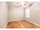 Bedroom with laminate flooring, ceiling fan, and a bright window at 910 W Redondo Dr, Gilbert, AZ 85233