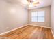 Bedroom featuring laminate flooring, gray walls, and a bright window at 910 W Redondo Dr, Gilbert, AZ 85233