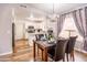 Bright dining area featuring wood floors, modern chandelier, and views of the kitchen at 910 W Redondo Dr, Gilbert, AZ 85233