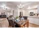 Open-concept living area featuring wood floors, modern chandelier, and views of the living area at 910 W Redondo Dr, Gilbert, AZ 85233