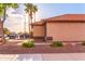 Beige single-story home with desert landscaping, tile roof, and mature trees at 910 W Redondo Dr, Gilbert, AZ 85233
