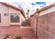 Beige single-story home with desert landscaping and an AC unit at 910 W Redondo Dr, Gilbert, AZ 85233