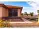 Charming single-story home with a terracotta-tiled roof, neutral stucco exterior, and drought-resistant landscaping at 910 W Redondo Dr, Gilbert, AZ 85233
