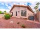 Beige single-story home with desert landscaping, tile roof, and an AC unit at 910 W Redondo Dr, Gilbert, AZ 85233