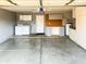 Spacious garage interior featuring ample storage cabinets, a work bench, a washing machine, and a dryer at 910 W Redondo Dr, Gilbert, AZ 85233