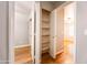 Hallway view leading to a bedroom and closet with plank flooring and neutral paint at 910 W Redondo Dr, Gilbert, AZ 85233