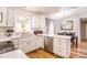Bright eat-in kitchen featuring white cabinets, stainless appliances, and an arched window at 910 W Redondo Dr, Gilbert, AZ 85233