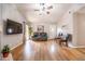 Cozy living room with a comfortable couch, hardwood floors, and a ceiling fan at 910 W Redondo Dr, Gilbert, AZ 85233