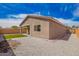 Well-maintained backyard with a small patch of green lawn and neutral-toned gravel at 947 E Wiley Way, Casa Grande, AZ 85122