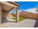 Backyard featuring an artificial turf lawn with stone landscaping at 947 E Wiley Way, Casa Grande, AZ 85122