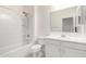 All white bathroom features a shower over tub and vanity with storage at 947 E Wiley Way, Casa Grande, AZ 85122