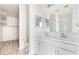 Bright bathroom features dual sinks, modern fixtures, and a large mirror at 947 E Wiley Way, Casa Grande, AZ 85122