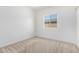 Bedroom features neutral carpet, a window, and white walls at 947 E Wiley Way, Casa Grande, AZ 85122
