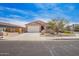 Inviting single-story home featuring a two-car garage and desert landscaping at 947 E Wiley Way, Casa Grande, AZ 85122