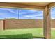 An inviting backyard has artificial turf, a covered patio, and a privacy wall at 9923 E Tahoe Ave, Mesa, AZ 85212
