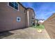 A home with a well-maintained backyard with artificial grass, a covered patio, and block wall at 9923 E Tahoe Ave, Mesa, AZ 85212