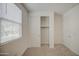Bright bedroom with a large window, carpet flooring and a closet with sliding doors at 9923 E Tahoe Ave, Mesa, AZ 85212