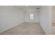 A carpeted bedroom showing one window, neutral color palette, and closet space at 9923 E Tahoe Ave, Mesa, AZ 85212