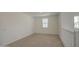 A bright bonus room features neutral carpet, fresh paint, and natural light from two windows at 9923 E Tahoe Ave, Mesa, AZ 85212