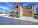 Charming two-story home showcasing an attached garage, desert landscaping, and a clean stucco exterior at 9923 E Tahoe Ave, Mesa, AZ 85212
