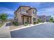 Charming two-story home showcasing a covered entryway, desert landscaping, and a clean stucco exterior at 9923 E Tahoe Ave, Mesa, AZ 85212