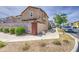 A property with a side-walkway and lush landscaping with a neighborhood street marker at 9923 E Tahoe Ave, Mesa, AZ 85212
