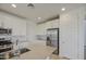 Spacious kitchen with a center island, modern appliances, and white cabinets at 9923 E Tahoe Ave, Mesa, AZ 85212