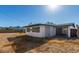 View of home exterior with chain link fence, stucco walls and a rolling metal door at 1038 E Northern Ave, Phoenix, AZ 85020