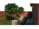 Backyard with seating and tiered garden beds with small fruit trees at 1038 E Northern Ave, Phoenix, AZ 85020