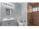 Updated bathroom featuring a neutral vanity with a tiled shower with a built-in seat at 1038 E Northern Ave, Phoenix, AZ 85020