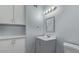 Gray and white bathroom with cabinet storage and countertop sink, plus a lighted mirror at 1038 E Northern Ave, Phoenix, AZ 85020