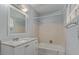 Cozy bathroom featuring tile flooring, shower over tub, and modern vanity at 1038 E Northern Ave, Phoenix, AZ 85020