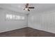 Spacious bedroom with window views, ceiling fan, and dark wood flooring at 1038 E Northern Ave, Phoenix, AZ 85020