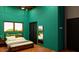 Modern bedroom with ceiling fan and bed with white linens and wood frame at 1038 E Northern Ave, Phoenix, AZ 85020