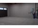 A spacious, unfinished garage features concrete floors, high ceilings, and room for two vehicles at 1038 E Northern Ave, Phoenix, AZ 85020