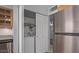 Bright kitchen featuring stainless steel fridge, laundry closet, and wood cabinets at 1038 E Northern Ave, Phoenix, AZ 85020