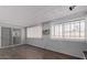 Comfortable living room features hardwood floors, sliding glass door, and mini-split AC at 1038 E Northern Ave, Phoenix, AZ 85020