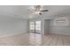 Open living room featuring tile flooring, a ceiling fan, and sliding glass doors at 1038 E Northern Ave, Phoenix, AZ 85020