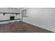 Bright living room with hardwood floors and fireplace against a white brick wall at 1038 E Northern Ave, Phoenix, AZ 85020