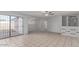 Open living room featuring tile flooring, ceiling fan, sliding glass doors and light gray walls at 1038 E Northern Ave, Phoenix, AZ 85020