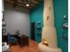 A stylish office area with a cozy fireplace, custom shelving, and ergonomic seating at 1038 E Northern Ave, Phoenix, AZ 85020