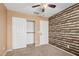 Bedroom with ample closet space and faux log accent wall at 11321 W Austin Thomas Dr, Surprise, AZ 85378