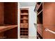 Custom walk-in closet with built-in shelving and drawers for optimal storage and organization at 11321 W Austin Thomas Dr, Surprise, AZ 85378