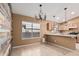 Bright dining area with tile flooring, a modern accent wall, and a window at 11321 W Austin Thomas Dr, Surprise, AZ 85378