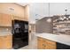 Kitchen view highlighting ample cabinetry, black refrigerator, and a peninsula overlooking an adjacent living area at 11321 W Austin Thomas Dr, Surprise, AZ 85378