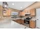 Open kitchen featuring stainless steel appliances, light wood cabinets, and bright countertops at 11321 W Austin Thomas Dr, Surprise, AZ 85378