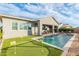 Backyard paradise with a sparkling pool, lush putting green, and inviting patio, ideal for recreation and relaxation at 11656 N San Clemente St, Surprise, AZ 85388
