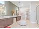 This spacious bathroom features dual sinks, lots of counter space and a roomy walk-in closet at 11656 N San Clemente St, Surprise, AZ 85388
