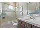 Well-lit bathroom offers a shower over tub, decorative tile and quartz countertop at 11656 N San Clemente St, Surprise, AZ 85388