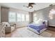 Serene bedroom features natural light, a ceiling fan, and a plush rug at 11656 N San Clemente St, Surprise, AZ 85388